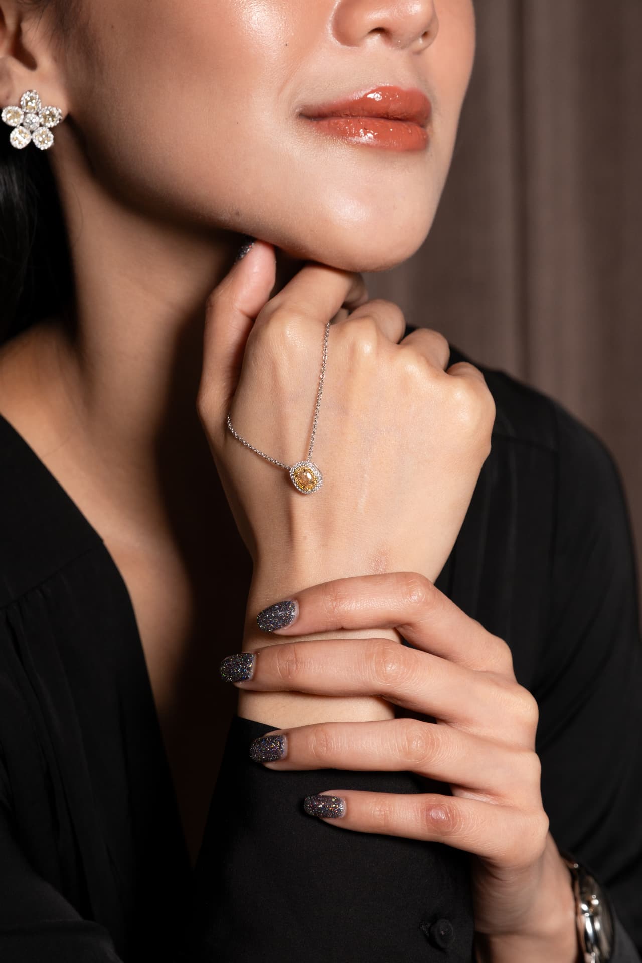 Yellow diamond pendant hand detail